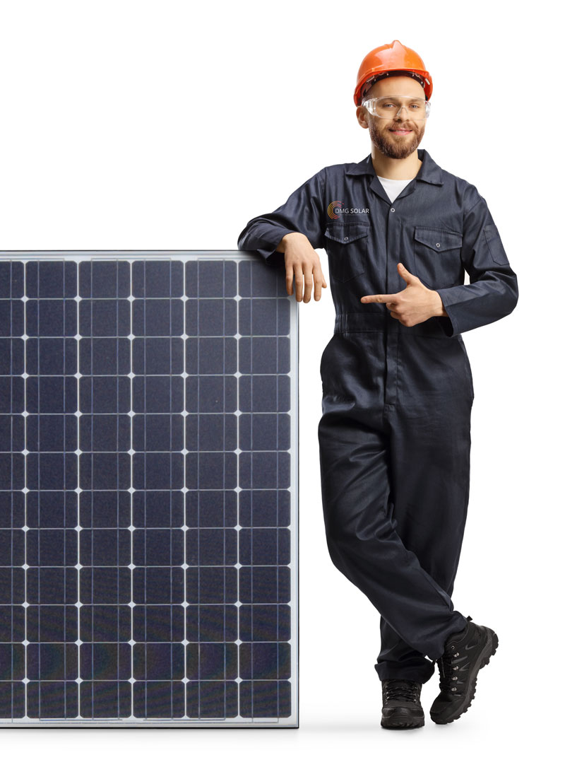 A man in a navy blue overall, orange safety helmet, and protective glasses stands next to a large solar panel, smiling and pointing at it with one hand, highlighting the reasons to convert to clean energy. A man in a navy blue overall, orange safety helmet, and protective glasses stands next to a large solar panel, smiling and pointing at it with one hand, highlighting the reasons to convert to clean energy.