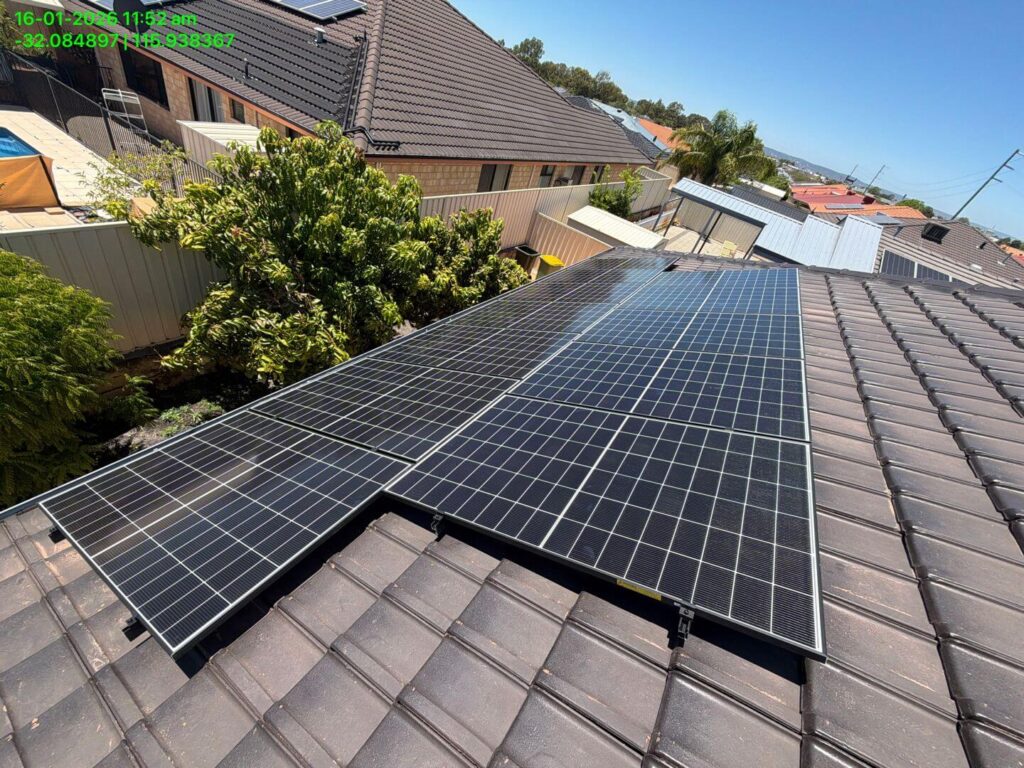 Rows of solar panels showcase a professional solar installation on a sloped, tiled roof in Canning Vale, with battery storage options available and leafy suburban views of neighbouring homes in the background.