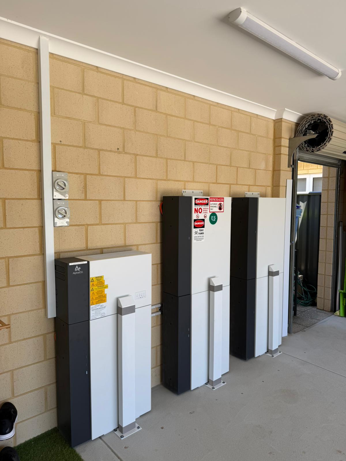 Side view of AlphaESS battery cabinets installed in a Hilbert garage