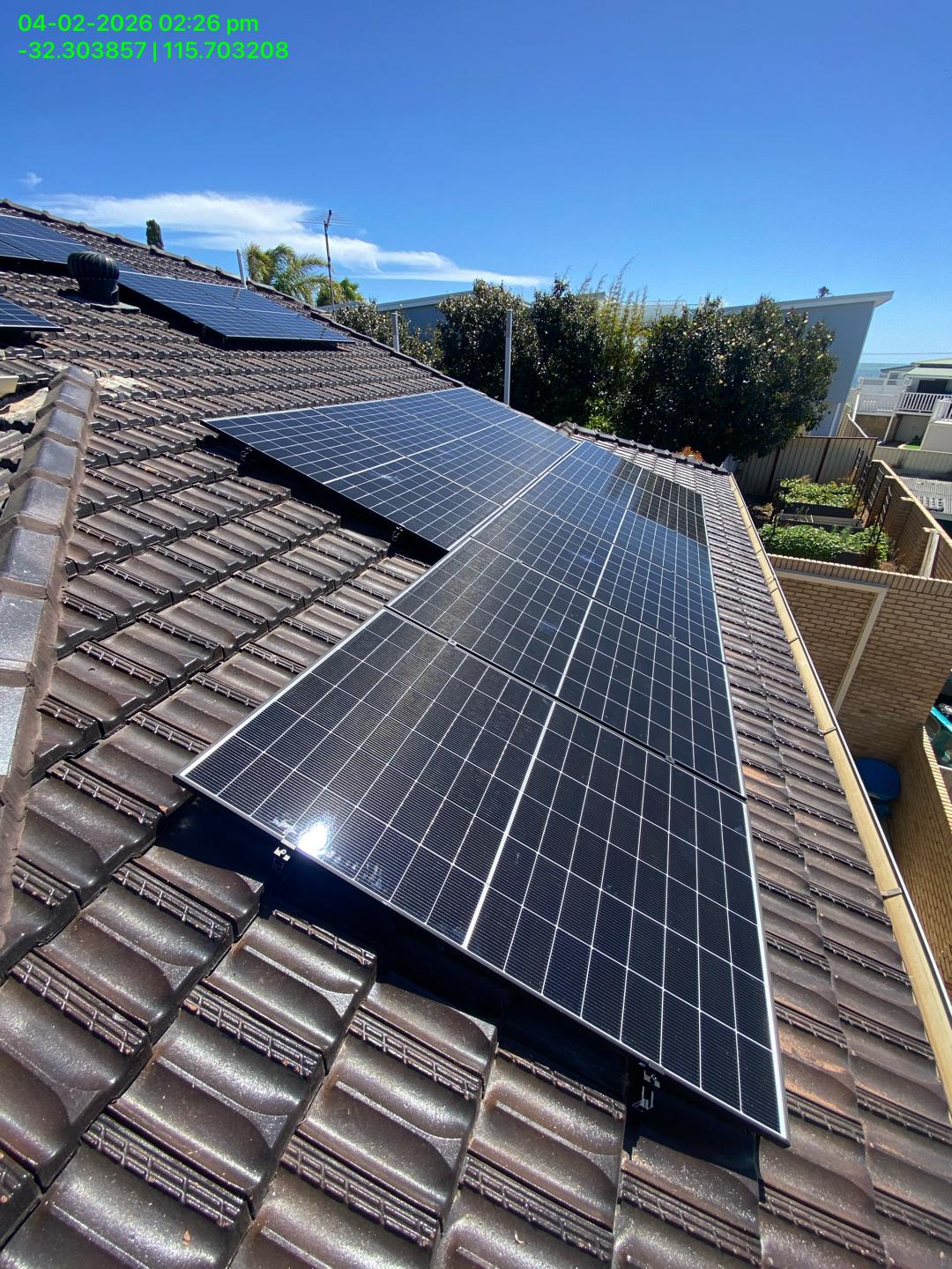 Close up of black framed solar panels on a Shoalwater tile roof