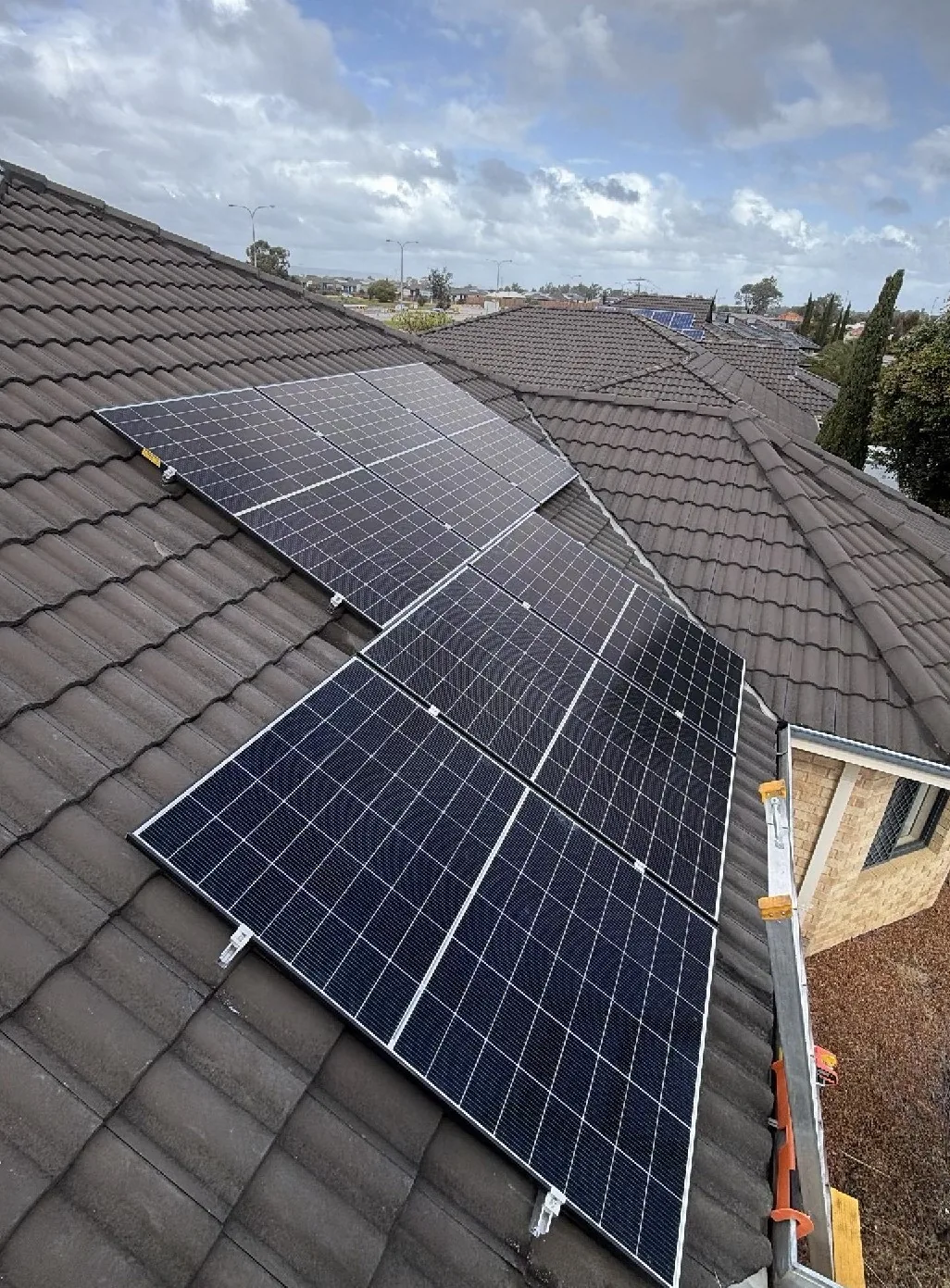 Trina solar panels in two runs on a dark tiled roof in Caversham