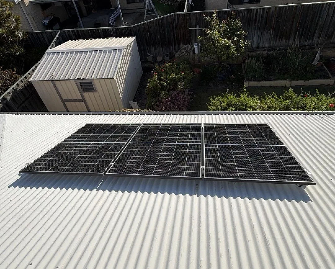 Row of Trina solar panels on a Colorbond roof above a garden in Ellenbrook