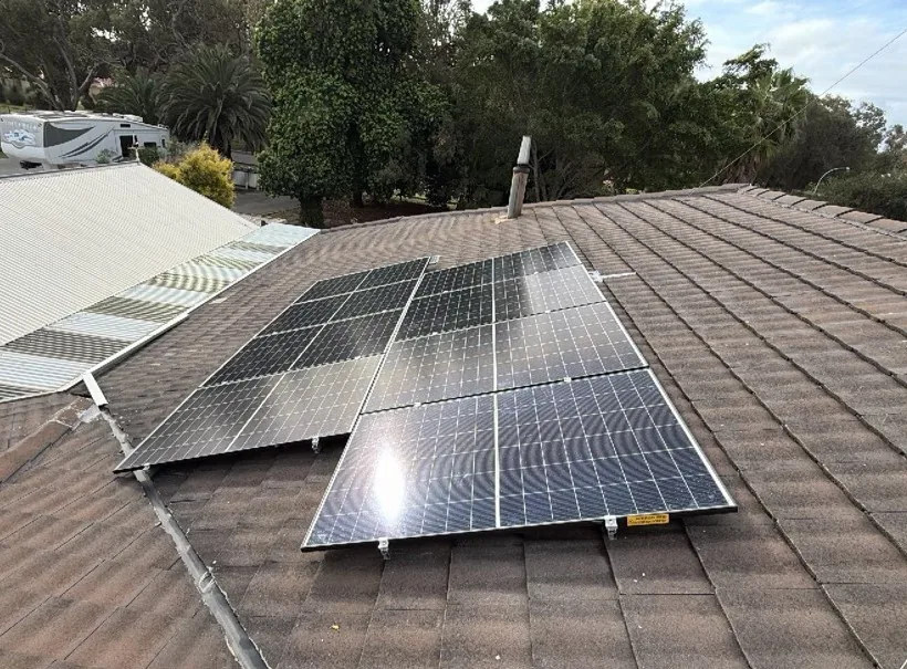 Solar panels on a brown tiled roof on a leafy Falcon block