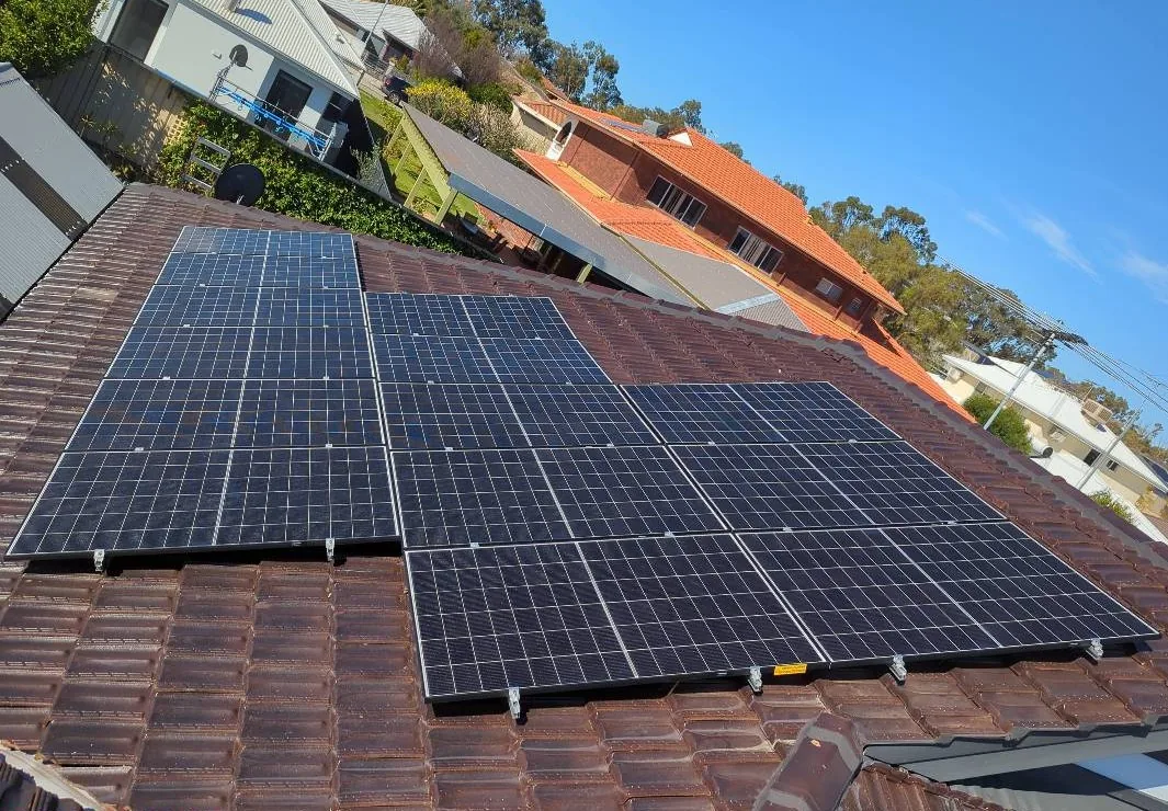 Trina Solar panels in three groups on a terracotta tiled roof in Gwelup