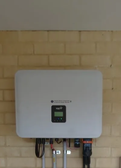 Close-up of a FoxESS H3 Smart hybrid inverter on a brick wall