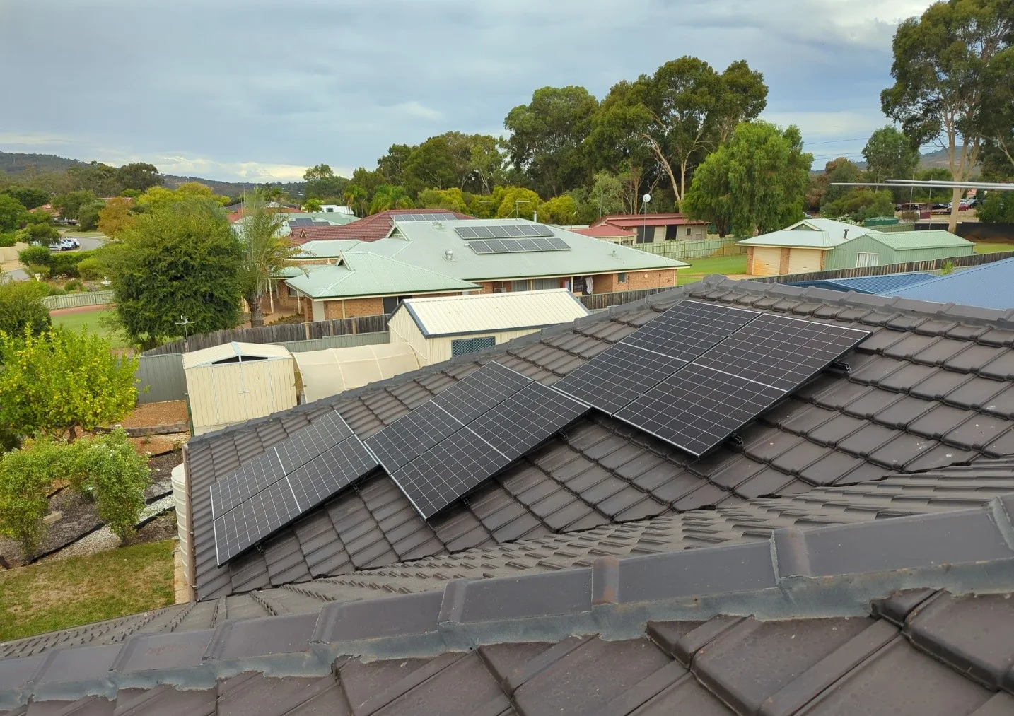 Stepped groups of solar panels on a brown tiled roof in Helena Valley