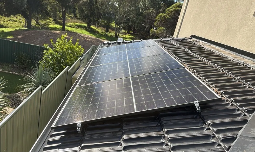 Solar panels on a charcoal tiled roof overlooking bushland in Winthrop