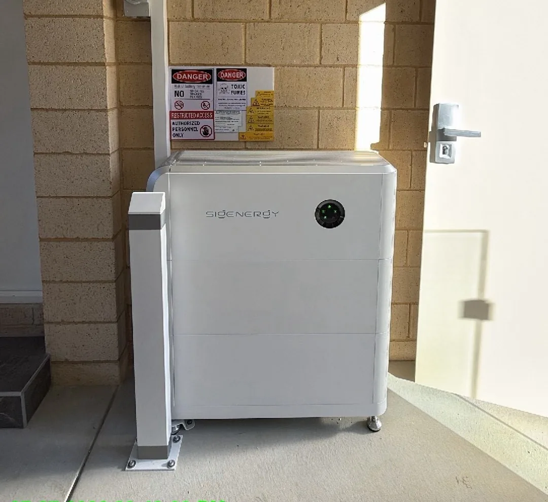 Sigenergy SigenStor 18.08kWh battery with safety bollard against cream brick